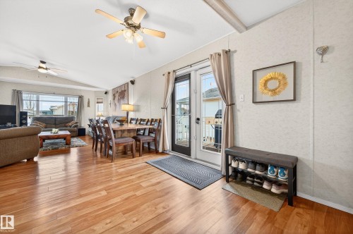 Spacious living area featuring hardwood flooring, a dining area, and glass patio doors - 1727 Jubilee Loop, Sherwood Park, AB - Indoor Photo Showing Living Room