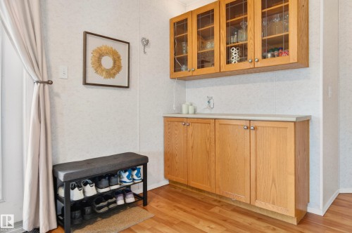 This functional space features wood flooring, upper and lower wood cabinetry with a light-colored countertop, and a light-colored wall finish - 1727 Jubilee Loop, Sherwood Park, AB - Indoor Photo Showing Other Room