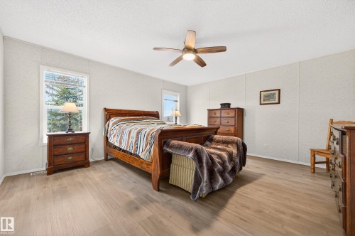 This room features light-toned flooring and white walls, creating a bright and airy atmosphere - 1727 Jubilee Loop, Sherwood Park, AB - Indoor Photo Showing Bedroom