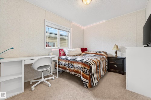 This bedroom features light-colored walls, carpeted flooring, and a window providing natural light - 1727 Jubilee Loop, Sherwood Park, AB - Indoor Photo Showing Bedroom