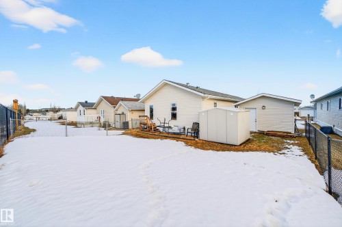 The property features a fenced yard, a patio area, and an exterior storage shed - 1727 Jubilee Loop, Sherwood Park, AB - Outdoor