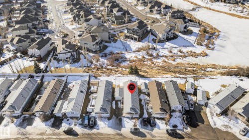 Aerial view of the property and its surrounding neighborhood, featuring residential streets and homes with pitched roofs - 1727 Jubilee Loop, Sherwood Park, AB - 
