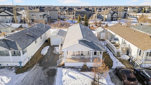 This property features a single-story dwelling with a covered front porch, a detached garage, and a separate shed - 1727 Jubilee Loop, Sherwood Park, AB - Outdoor