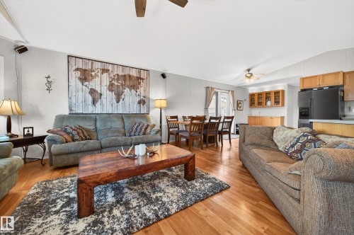 This property features an open-concept living area with hardwood flooring, a dining area, and a kitchen - 1727 Jubilee Loop, Sherwood Park, AB - Indoor Photo Showing Living Room