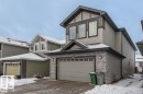 The property features a two-story design with a prominent gable roof, light gray siding, and stone accents on the facade - 3608 46 Avenue, Beaumont, AB  - Outdoor 