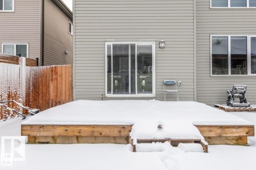 The property features a wooden deck with steps, a sliding glass patio door, and multiple windows on the exterior - 3608 46 Avenue, Beaumont, AB - Outdoor With Exterior