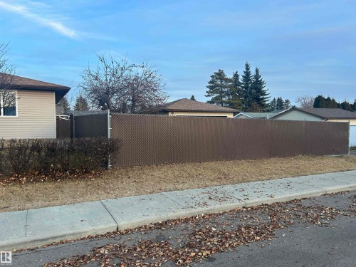 The property features a brown chain link fence, providing privacy and security - 14911 77 Street Nw, Edmonton, AB - Outdoor