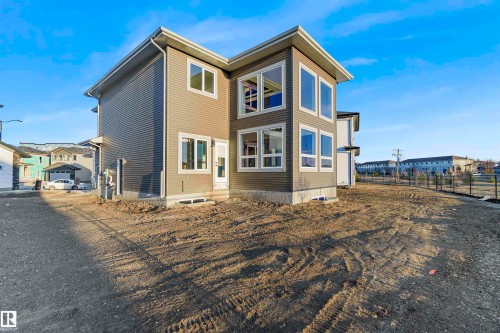 The property features a contemporary architectural style with clean lines and a neutral color palette - 368 Creekside Green, Leduc, AB - Outdoor