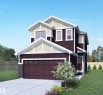 The property features a dark-toned exterior with light-colored trim, a two-car garage, and a concrete driveway - 2206 Crossbill Link, Edmonton, AB  - Outdoor 