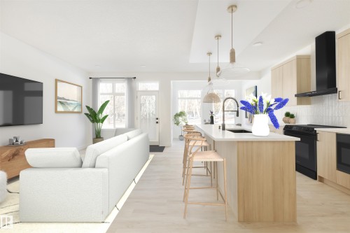 The open concept living area features light wood flooring and white walls, creating a bright and airy atmosphere - 2206 Crossbill Link, Edmonton, AB - Indoor Photo Showing Kitchen With Upgraded Kitchen