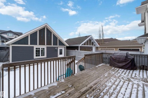 The property features a spacious wooden deck with railings, providing an outdoor area - 5014 Dewolf Road, Edmonton, AB 