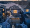 The property features a contemporary exterior with a two-car garage, a paved driveway, and a partially snow-covered front yard - 9 Prospect Place, Spruce Grove, AB  - Outdoor 