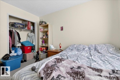 This bedroom features a closet with shelving and hanging rods - 13304 130 Avenue, Edmonton, AB - Indoor Photo Showing Bedroom