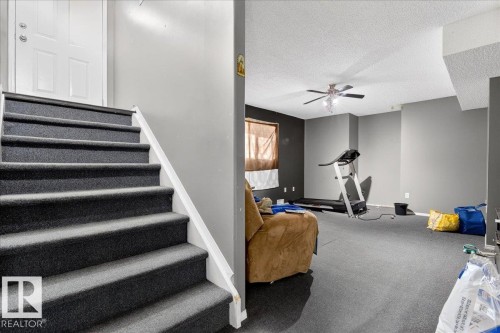 This room features a ceiling fan, a window with blinds, and carpeted flooring - 13304 130 Avenue, Edmonton, AB - Indoor Photo Showing Other Room