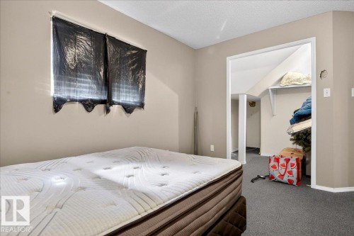 The room features light-colored walls and grey carpeting - 13304 130 Avenue, Edmonton, AB - Indoor Photo Showing Bedroom