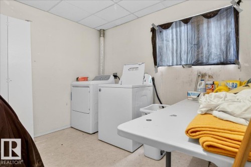 This utility space includes a washer and dryer, providing convenience - 13304 130 Avenue, Edmonton, AB - Indoor Photo Showing Laundry Room