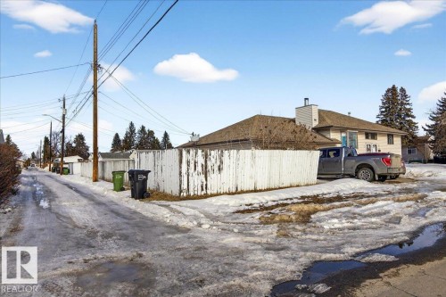 The property features a private fenced yard and a paved driveway for off-street parking - 13304 130 Avenue, Edmonton, AB - Outdoor
