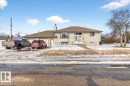 The property features a split-level design with light-colored siding and a brown roof - 13304 130 Avenue, Edmonton, AB  - Outdoor 