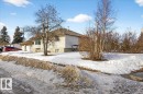 The property features a white exterior with a brown roof and a double garage - 13304 130 Avenue, Edmonton, AB  - Outdoor 