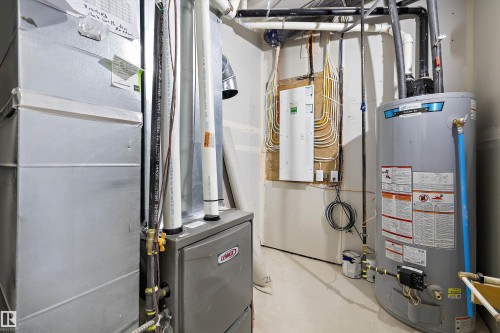 The property includes a water heater and a furnace - 8321 81Ave, Edmonton, AB - Indoor Photo Showing Basement
