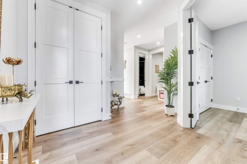 The property features light-toned hardwood flooring throughout the hallway - 1531 151 Avenue, Edmonton, AB - Indoor Photo Showing Other Room