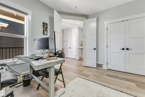 This space features light-toned flooring, white walls, and a window with blinds - 1531 151 Avenue, Edmonton, AB - Indoor