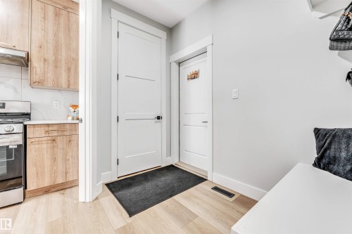 The property features light wood flooring, white walls, and white interior doors - 1531 151 Avenue, Edmonton, AB - Indoor