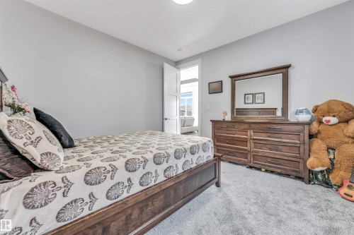 This room features light grey walls and grey carpeting, providing a neutral backdrop - 1531 151 Avenue, Edmonton, AB - Indoor Photo Showing Bedroom