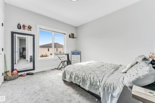 The property features a bright room with light grey walls and light grey carpet - 1531 151 Avenue, Edmonton, AB - Indoor Photo Showing Bedroom