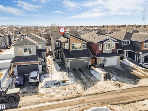 The property features a two-story design with a gray exterior, dark roof, and an attached single-car garage - 1531 151 Avenue, Edmonton, AB - Outdoor With Facade