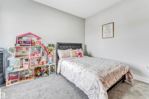 This room features light grey walls and grey carpet flooring - 1531 151 Avenue, Edmonton, AB - Indoor Photo Showing Bedroom