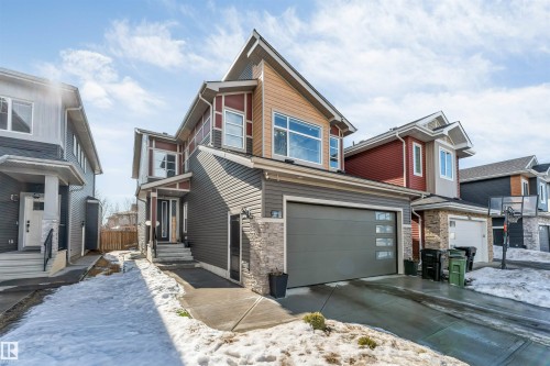 The property features a two-story design with a mix of siding and stone accents on the facade - 1531 151 Avenue, Edmonton, AB - Outdoor With Facade