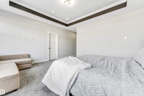 Bedroom featuring a tray ceiling with recessed lighting and a modern light fixture - 1531 151 Avenue, Edmonton, AB - Indoor Photo Showing Bedroom