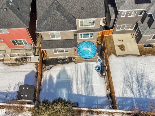 The property features a fenced yard with a deck and an above-ground pool - 1531 151 Avenue, Edmonton, AB - Outdoor