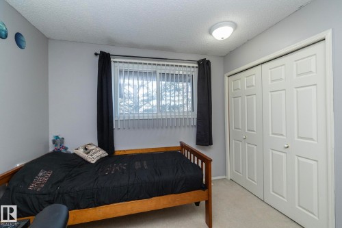 This room features a window with blinds and dark curtains, offering natural light - 6 Glaewyn Estates, St. Albert, AB - Indoor Photo Showing Bedroom