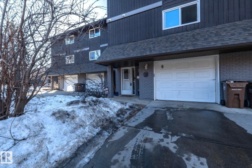 The property features a dark-colored exterior with a shingled roof and white-framed windows - 6 Glaewyn Estates, St. Albert, AB - Outdoor