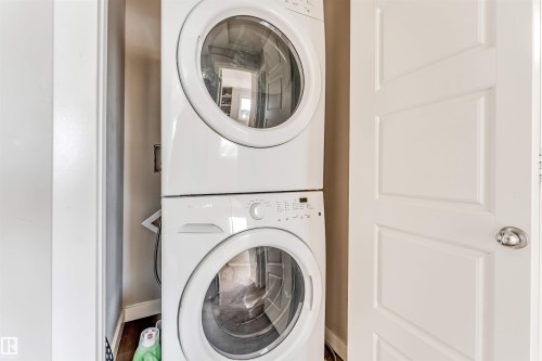 Laundry area featuring a stacked washer and dryer unit - 1624 33A Street, Edmonton, AB - Indoor Photo Showing Laundry Room