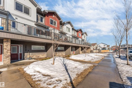 The property features a multi-story exterior with varying siding finishes, including horizontal siding and stone accents - 1624 33A Street, Edmonton, AB - Outdoor With Balcony With Facade