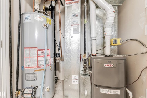 Utility area featuring a water heater and furnace - 1624 33A Street, Edmonton, AB - Indoor Photo Showing Basement