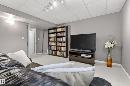 Finished basement space featuring light-colored carpeting, recessed lighting, and a ceiling with acoustic tiles - 1119 Rutherford Close, Edmonton, AB - Indoor