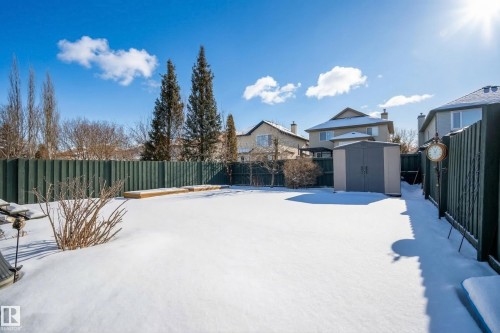 The property features an extensive backyard with a shed, a privacy fence, and mature trees - 1119 Rutherford Close, Edmonton, AB - Outdoor