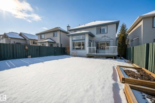 The property features a spacious backyard with a deck and raised garden beds - 1119 Rutherford Close, Edmonton, AB - Outdoor