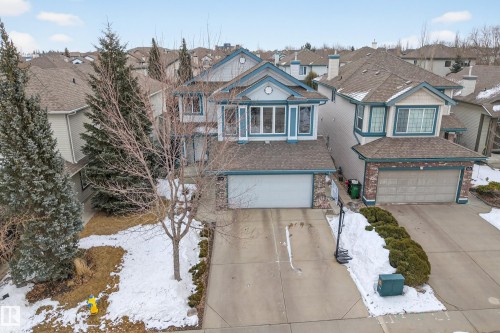 The property features a concrete driveway and an attached garage - 1119 Rutherford Close, Edmonton, AB - Outdoor With Facade