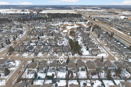 Aerial view of the property and its surrounding residential neighborhood, featuring established homes with dark roofs and snow-dusted grounds - 1119 Rutherford Close, Edmonton, AB - Outdoor With View