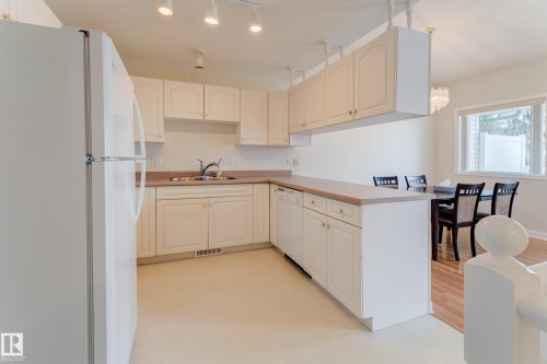 The kitchen features white cabinetry - 5 308 Jackson Road, Edmonton, AB - Indoor Photo Showing Kitchen With Double Sink