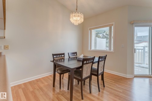 Dining space featuring a vaulted ceiling with a hanging light fixture,  and a large window - 5 308 Jackson Road, Edmonton, AB - Indoor Photo Showing Dining Room