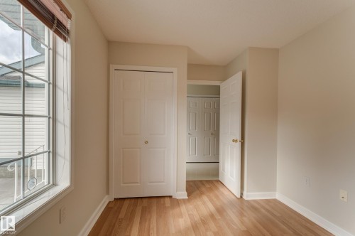 This room features warm-toned flooring, light-colored walls, and a large window. - 5 308 Jackson Road, Edmonton, AB - Indoor Photo Showing Other Room