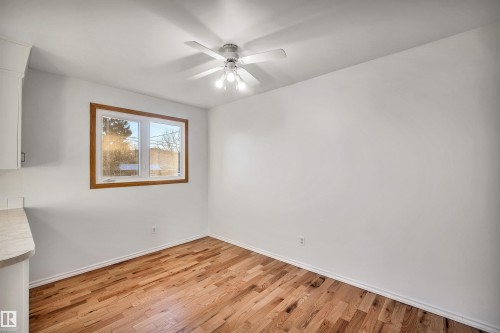 Unfurnished dining area featuring light wood-style floors and a ceiling fan - 11231 41 Avenue, Edmonton, AB - Indoor Photo Showing Other Room