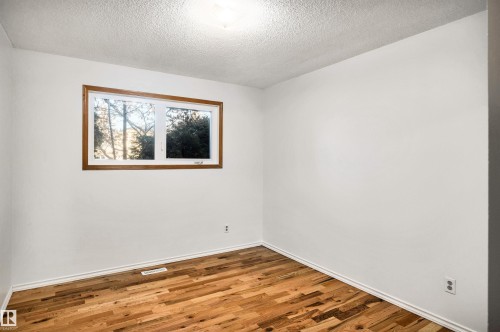 Unfurnished room with a textured ceiling and wood finished floors - 11231 41 Avenue, Edmonton, AB - Indoor Photo Showing Other Room