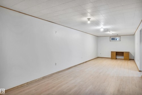 Basement with light wood-style floors and a desk - 11231 41 Avenue, Edmonton, AB - Indoor